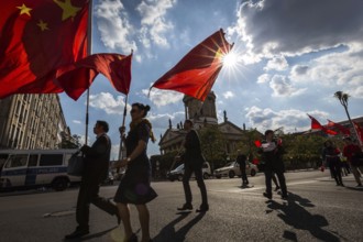 DEU Germany Germany Berlin A group with Chinese flags walks across the Gendarmenmarkt to