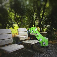 DEU Germany Germany Berlin A lonely blanket with football motifs lies abandoned on seats in a park