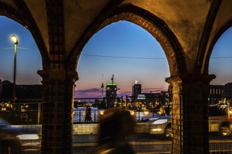 DEU Germany Germany Berlin Evening atmosphere seen through an arch of the Oberbaum Bridge