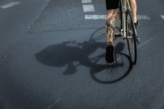 DEU Germany Germany Berlin A huge tattoo adorns the calf of a cyclist just starting out on