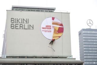 DEU Germany Germany Berlin A worker removes the outdoor advertising for a spring installation in