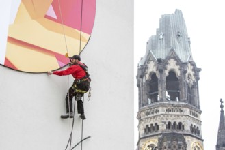 DEU Germany Germany Berlin A worker removes the outdoor advertising for a spring installation in