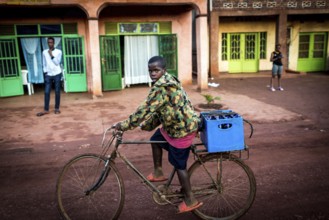 RWA RWANDA Rwanda Rukara A cyclist wearing a camouflage jacket transports drinks
