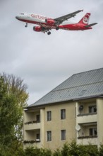 DEU Germany Germany Berlin Landing approach of an Air Berlin aircraft over residential buildings at