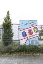 DEU Germany Germany Berlin A closed Air Berlin hangar with graffiti by Thierry Noir on pieces of