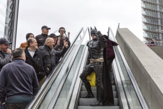 DEU Germany Germany Berlin A man wearing a Batman costume walks across Potsdamer Platz
