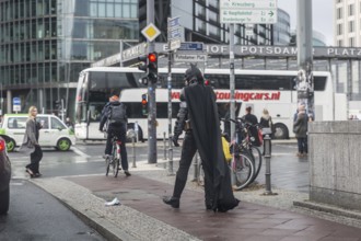 DEU Germany Germany Berlin A man wearing a Batman costume walks across Potsdamer Platz