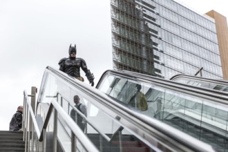 DEU Germany Germany Berlin A man wearing a Batman costume walks across Potsdamer Platz