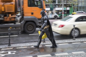 DEU Germany Germany Berlin A man wearing a Batman costume walks across Potsdamer Platz