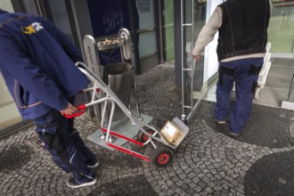 DEU Germany Germany Berlin A courier with grocery orders enters the Europe Centre while a parcel
