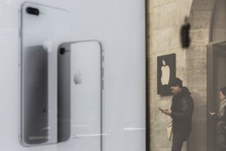 DEU Germany Germany Berlin People with smartphones leave the Applestore on Kurfürstendamm. They are
