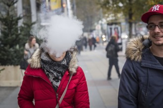 DEU Germany Germany Berlin A couple with an e-cigarette blowing out vapour