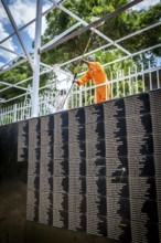 RWA RWANDA RUANDA Kigali Working at the memorial in front of a list of names in preparation for the
