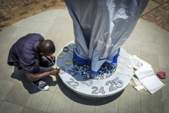 RWA RWANDA RUANDA Kigali An assistant completing the flame in preparation for the genocide