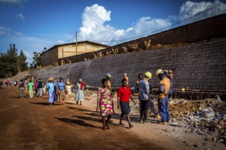 RWA RWANDA RUANDA Kigali Pedestrians walk through a road construction site in Gikondo district