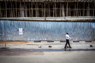 RWA RWANDA RUANDA Kigali A man passes a construction site in the Kiyovu banking district