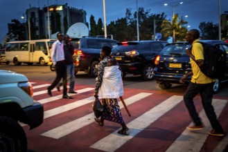 RWA RWANDA RUANDA Kigali A mother and child cross a zebra crossing in Remera district