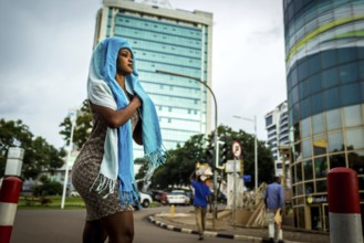 RWA RWANDA RUANDA Kigali A woman with scarves around her head walks in the banking district of