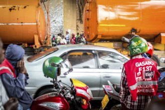RWA RWANDA RUANDA Kigali Taxi drivers with motorbikes and bicycles wait under a bridge for the end