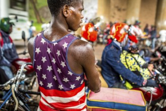 RWA RWANDA RUANDA Kigali Taxi drivers with motorbikes and bicycles wait under a bridge for the end