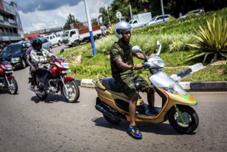 RWA RWANDA RUANDA Kigali A youth in camouflage fashion on a scooter