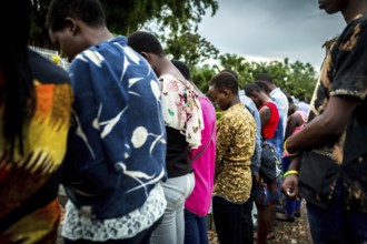 RWA RWANDA RUANDA Kigali A youth group stands in front of a mass grave at the genocide memorial