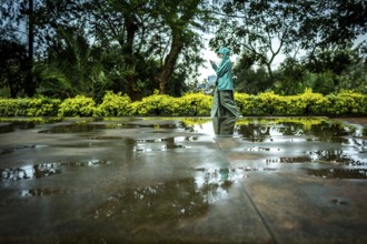 RWA RWANDA RUANDA Kigali A visitor plays in the puddles of water on a mass grave at the genocide