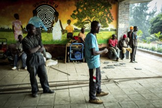 RWA RWANDA RUANDA Kigali workers take a break due to rain showers. They are renovating the