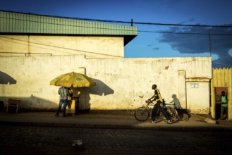 RWA RWANDA RUANDA Kigali A cyclist and a parasol cast their shadows on the wall