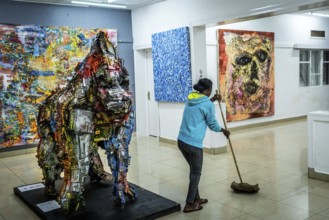 RWA RWANDA RUANDA Kigali A cleaning lady mops during the party at the Inema Gallery. Artists,