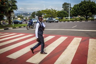 RWA RWANDA RUANDA Kigali A pedestrian in a suit crosses a zebra crossing in the banking district of