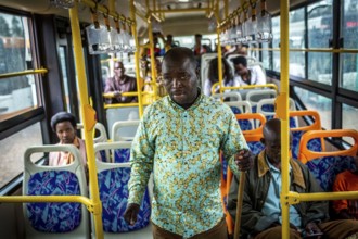 RWA RWANDA RUANDA Kigali A blind man walks through a waiting bus to beg