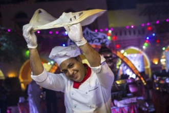 Egypt Hurghada A baker turns his bread dough in the air during an evening promotional event for