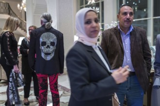 Egypt Hurghada Guests wait in a hotel lobby for the start of an event. One guest is wearing a