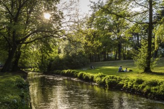 DEU Germany Germany Berlin People enjoying the sun on the banks of the Panke in Bürgerpark Pankow