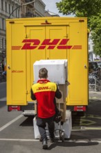 DEU Germany Germany Berlin A courier delivers parcels on Bergmannstrasse