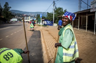 RWA RWANDA RUANDA Kigali Street cleaners clean a road leading to the Genocide Memorial on the