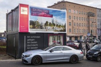 DEU Germany Germany Berlin A luxury car parked in front of a presentation container for new