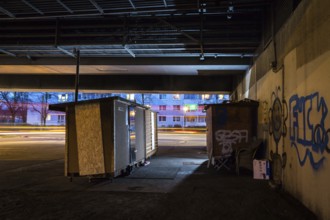 DEU Germany Germany Berlin Wooden shacks financed by donations stand under the motorway bridge in