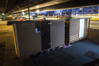 DEU Germany Germany Berlin Wooden shacks financed by donations stand under the motorway bridge in