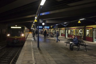 DEU Germany Germany Berlin Scenes in and around the S-Bahn. Passengers waiting for a train in