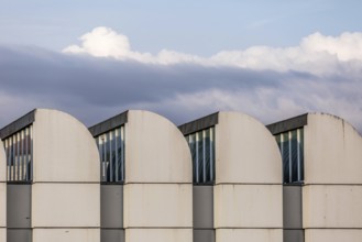 DEU Germany Germany Berlin The towers of the Bauhaus Museum are lined up against a cloudy sky. The