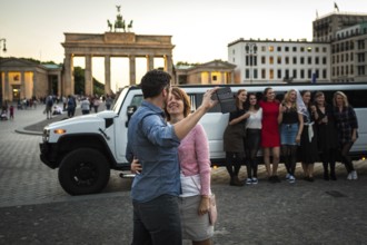 DEU Germany Germany Berlin Young woman pose with a rented stretch limousine in front of the