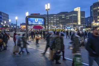 DEU Germany Germany Berlin View over Alexanderplatz with subway and sausage vendor at blue hour