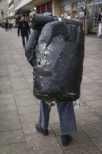 DEU Germany Germany Berlin A homeless man carries a huge bag with his belongings through the city