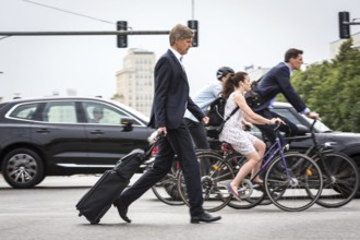 DEU Germany Germany Berlin Scene with cyclists in traffic in the capital Karl-Marx-Alle, corner of