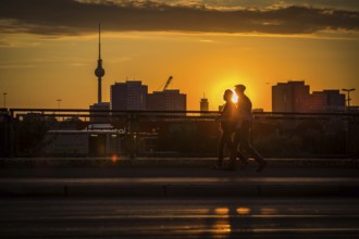 DEU Germany Germany Berlin Cyclists and pedestrians at sunset on the Warsaw Bridge