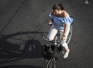 DEU Germany Germany Berlin Scene with cyclists on Schlossstraße in Steglitz. Woman with mobile