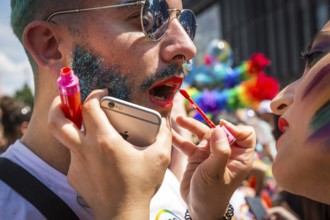 DEU Germany Germany Berlin Scenes of the Christopher Street Day CSD on a hot Saturday . Woman makes