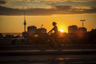 DEU Germany Germany Berlin Cyclists and pedestrians at sunset on the Warsaw Bridge